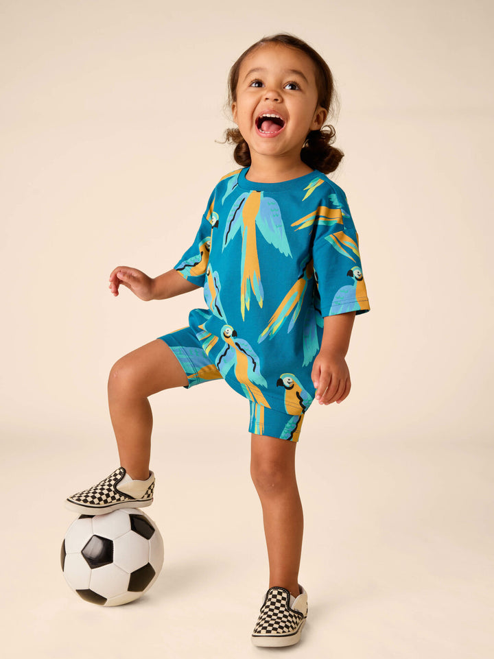 TEA COLLECTION NIÑA SHORT PRINTED BIKE BLUE & YELLOW MACAWS